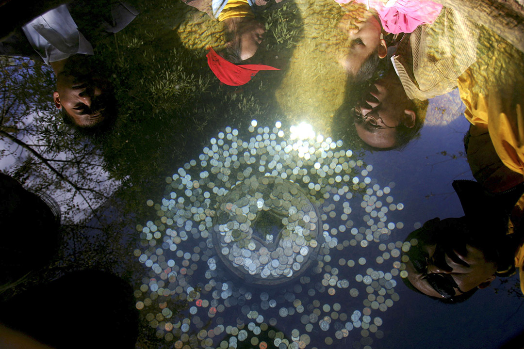 2006年11月27日昆明,遊人放置硬幣入公園噴泉水池為祈求好運。