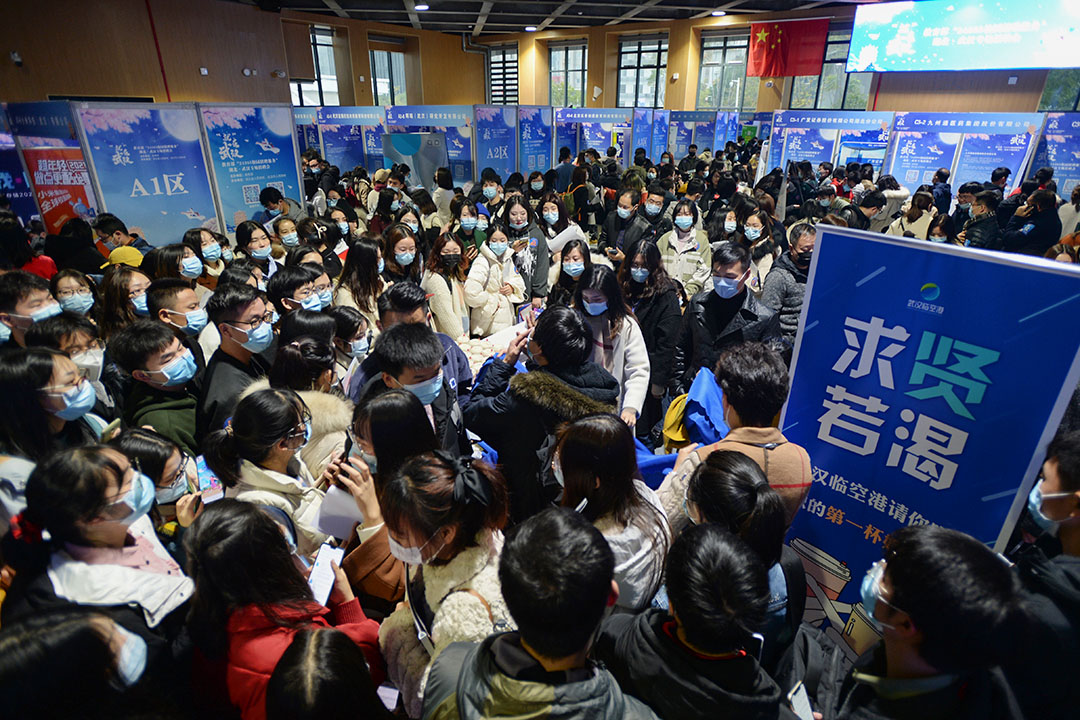 2020年12月2日中國武漢，戴著口罩的畢業生於湖北省武漢市的體育館參加招聘會。