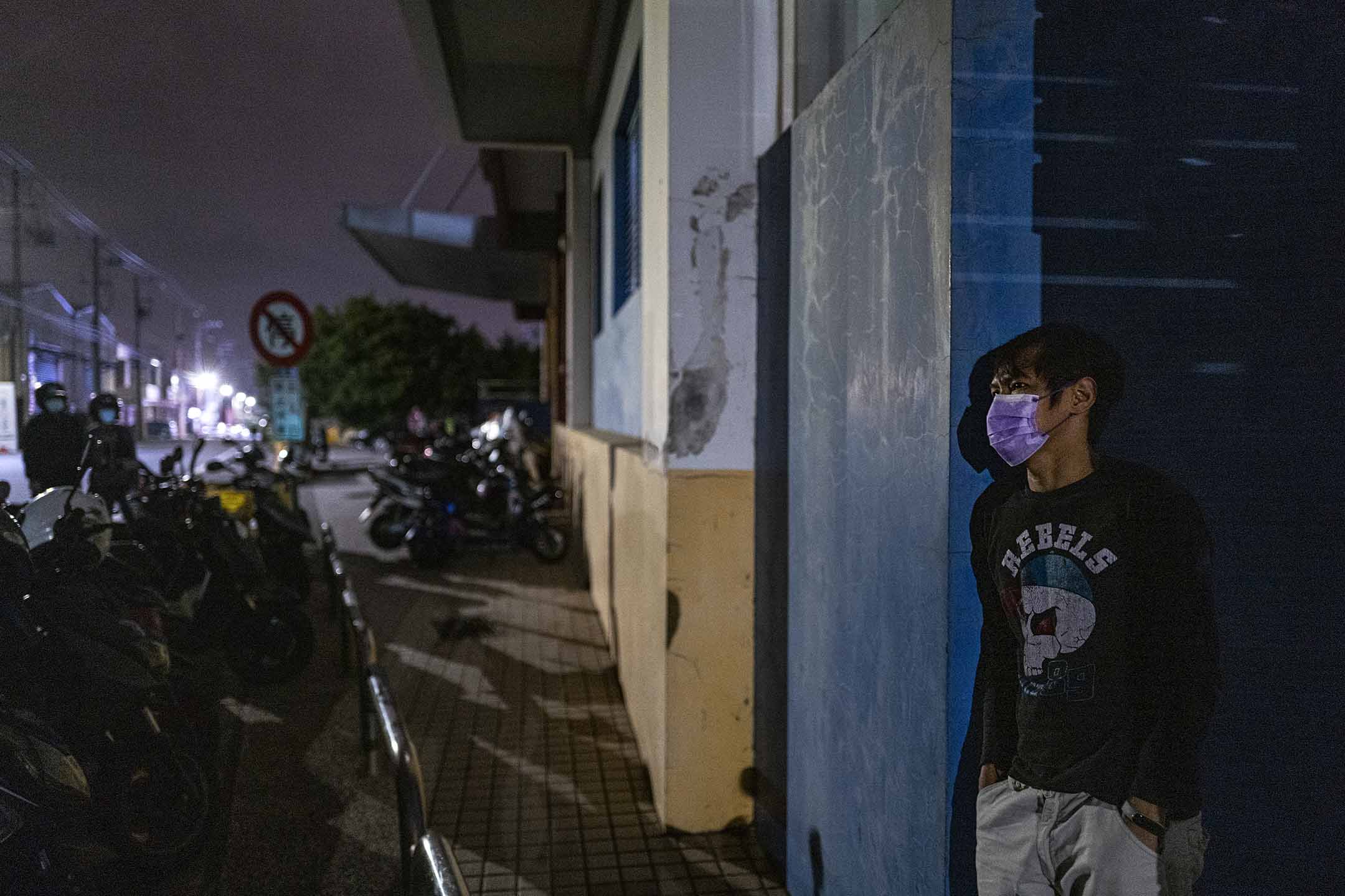 2022年5月8日,台湾桃园,一名移工站在宿舍范围内。