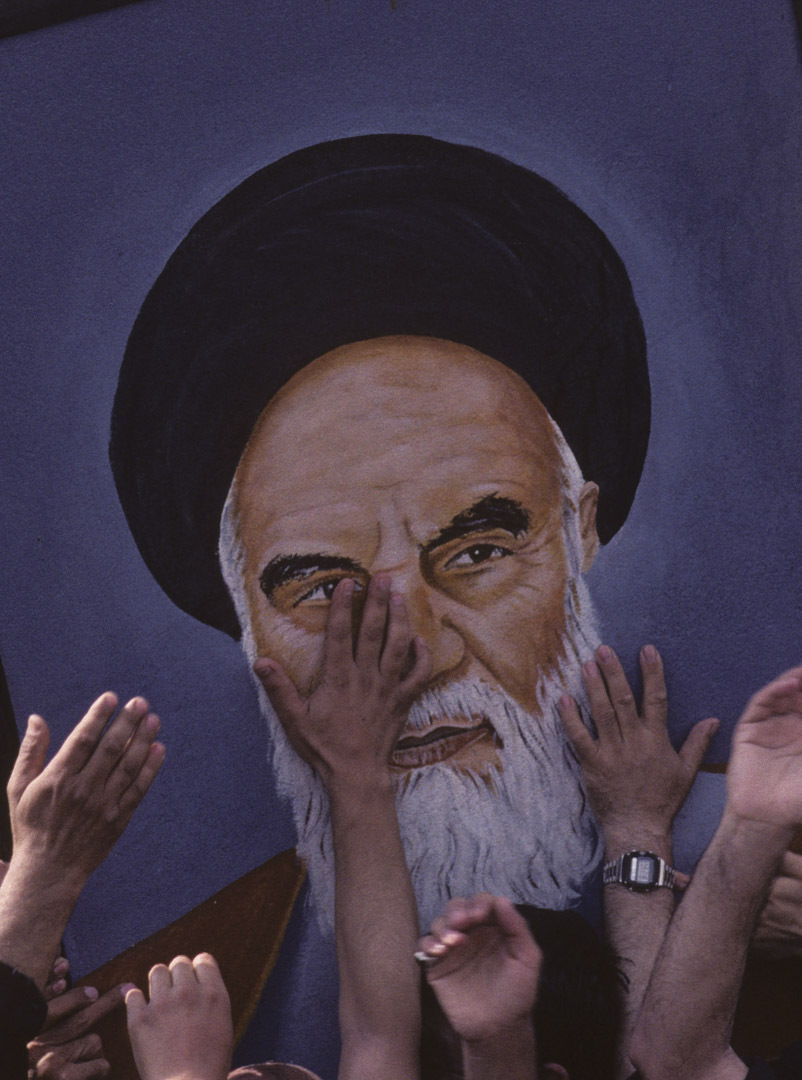 1989年6月5日,伊朗德黑蘭,哀悼者伸手觸摸阿亞圖拉·霍梅尼 (Ayatollah Khomeini) 的肖像。