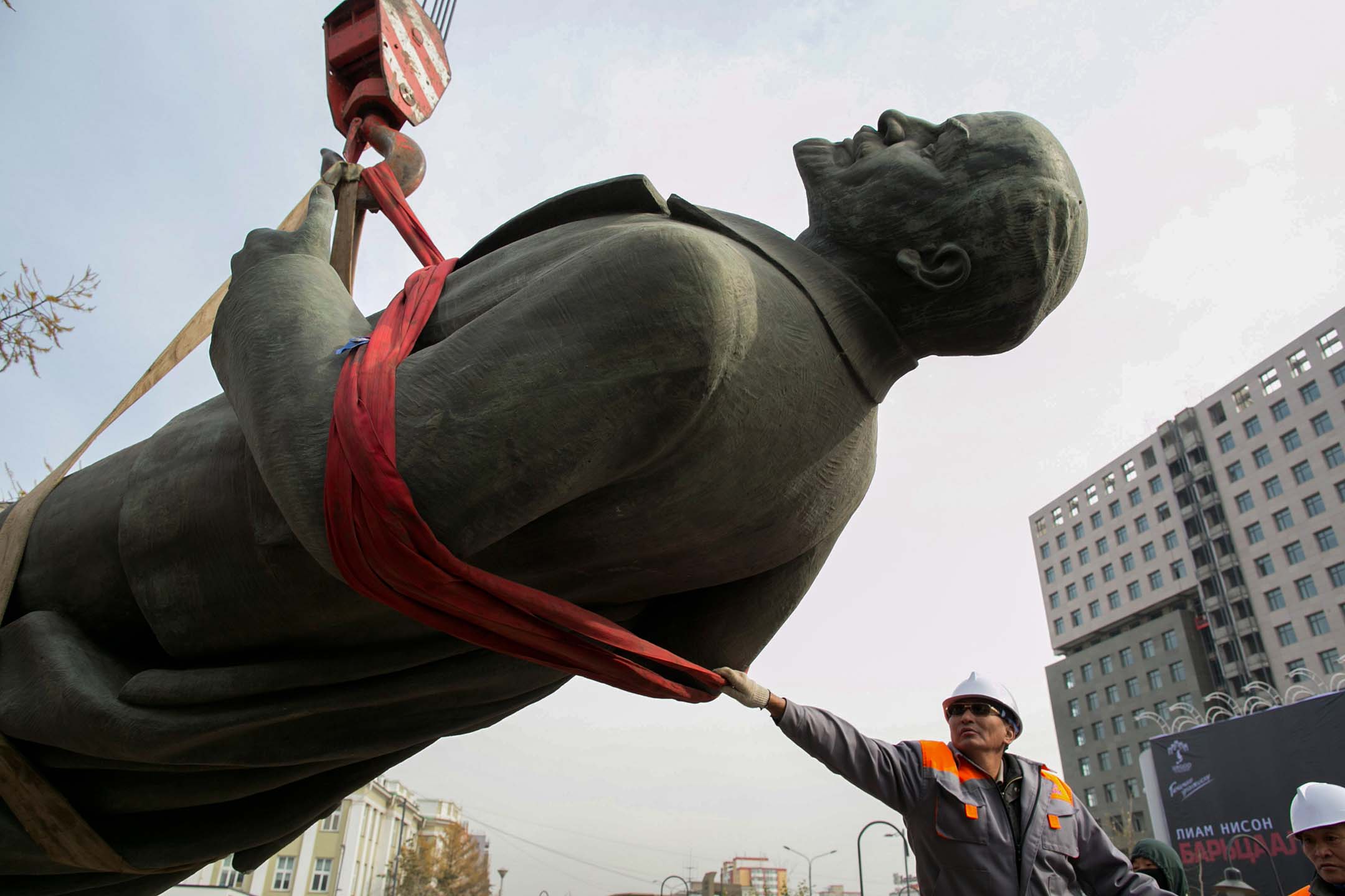 2012年10月14日,蒙古烏蘭巴托,一名工人抓住列寧雕像,用起重機將其拆除並放在卡車上。