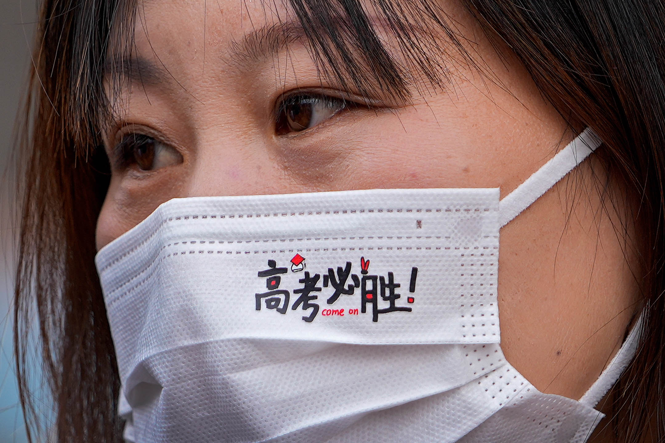 2021年6月7日,中國北京,一名高考生戴著寫有「高考必勝」口罩。攝:Andy Wong/AP/達志影像