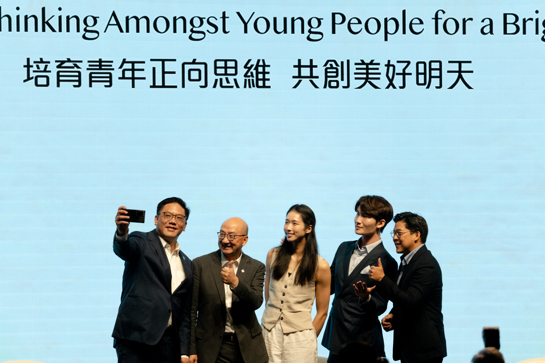 2024年8月10日,江旻憓(中)出席由政府主办的“青年发展高峰论坛”,在台上与各嘉宾合照。摄:Ryan Lai/端传媒