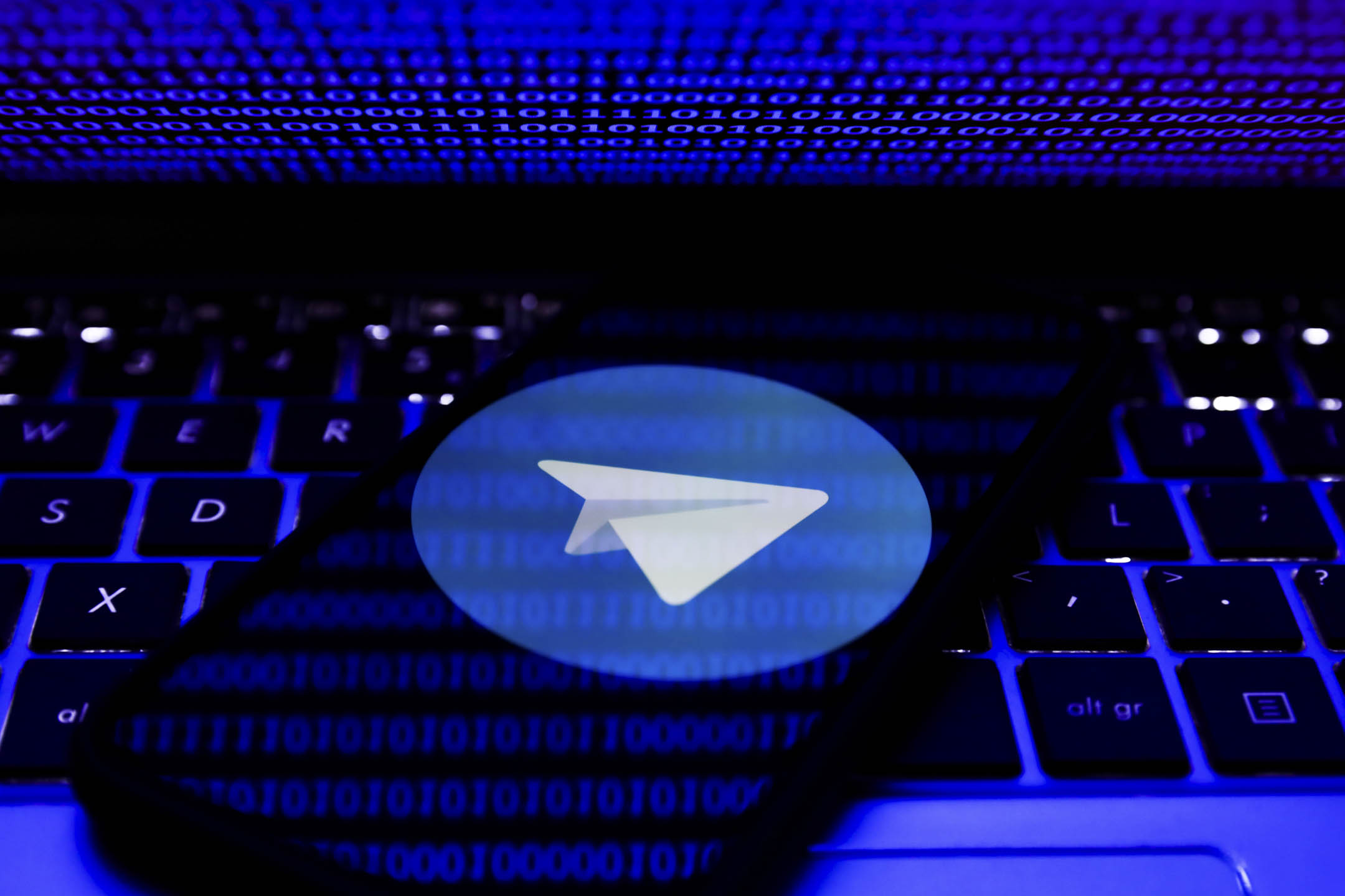 手機螢幕上顯示的Telegram 標誌和筆記型電腦。攝：Jakub Porzycki/NurPhoto via Getty Images